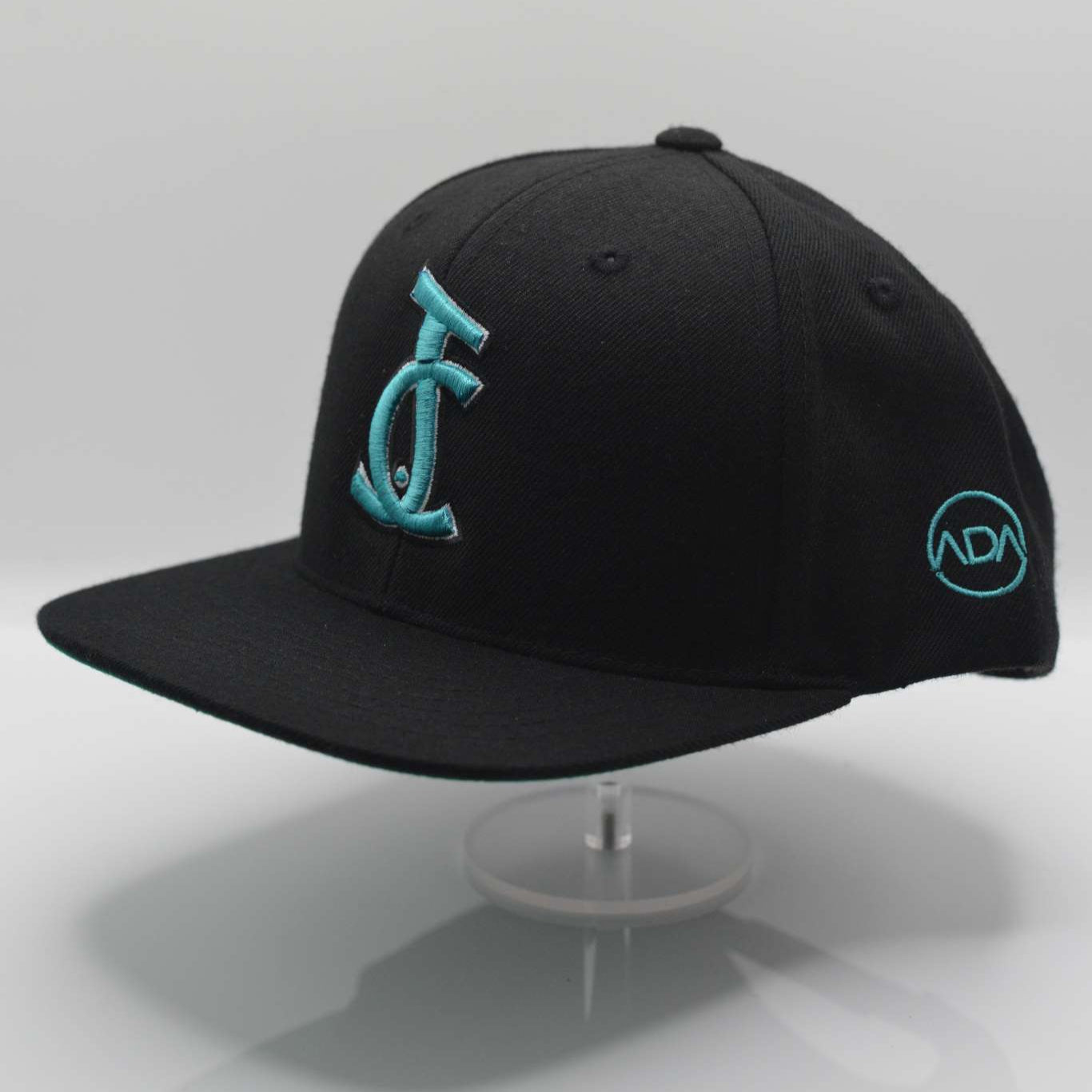 Bold faith meets streetwear. The JC Signature Snapback in black and teal features Christ-centered embroidery and premium fit. Wear your faith loud and clear.