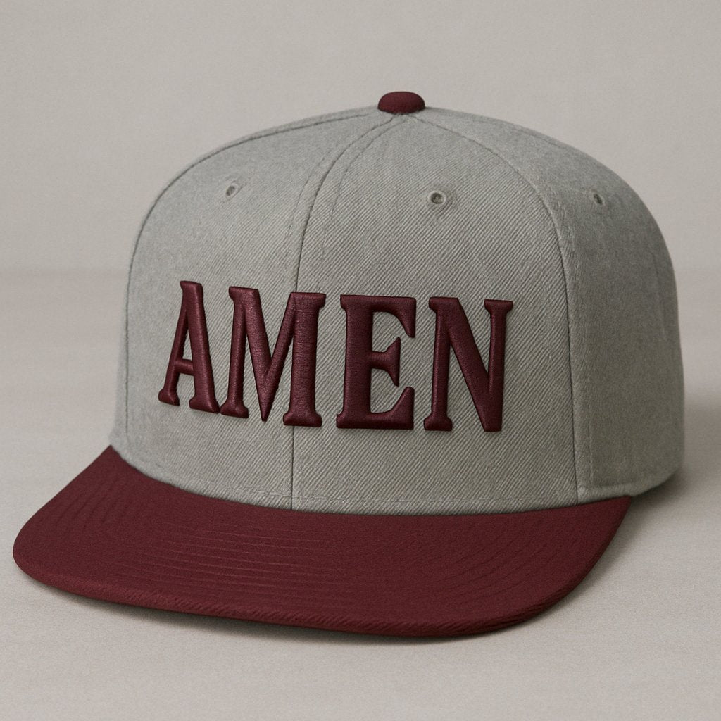 Two-tone snapback hat with a gray crown and burgundy brim, featuring bold 3D ‘AMEN’ embroidery on the front, designed by Aaron David Apparel