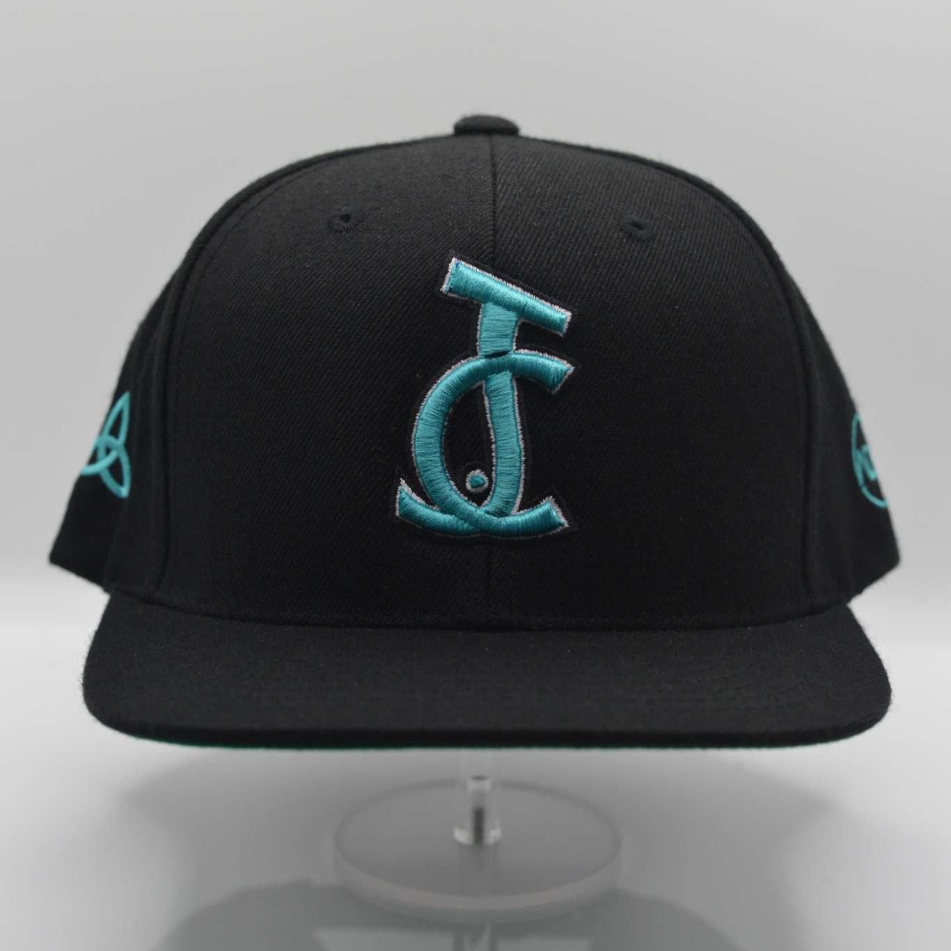 Bold faith meets streetwear. The JC Signature Snapback in black and teal features Christ-centered embroidery and premium fit. Wear your faith loud and clear.

