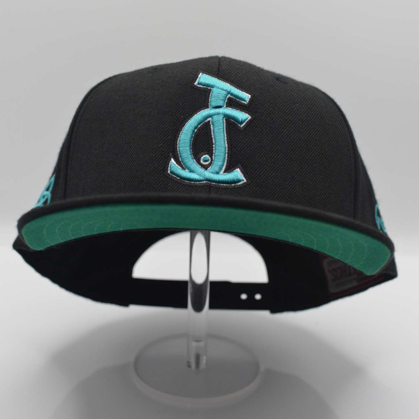 Bold faith meets streetwear. The JC Signature Snapback in black and teal features Christ-centered embroidery and premium fit. Wear your faith loud and clear.

