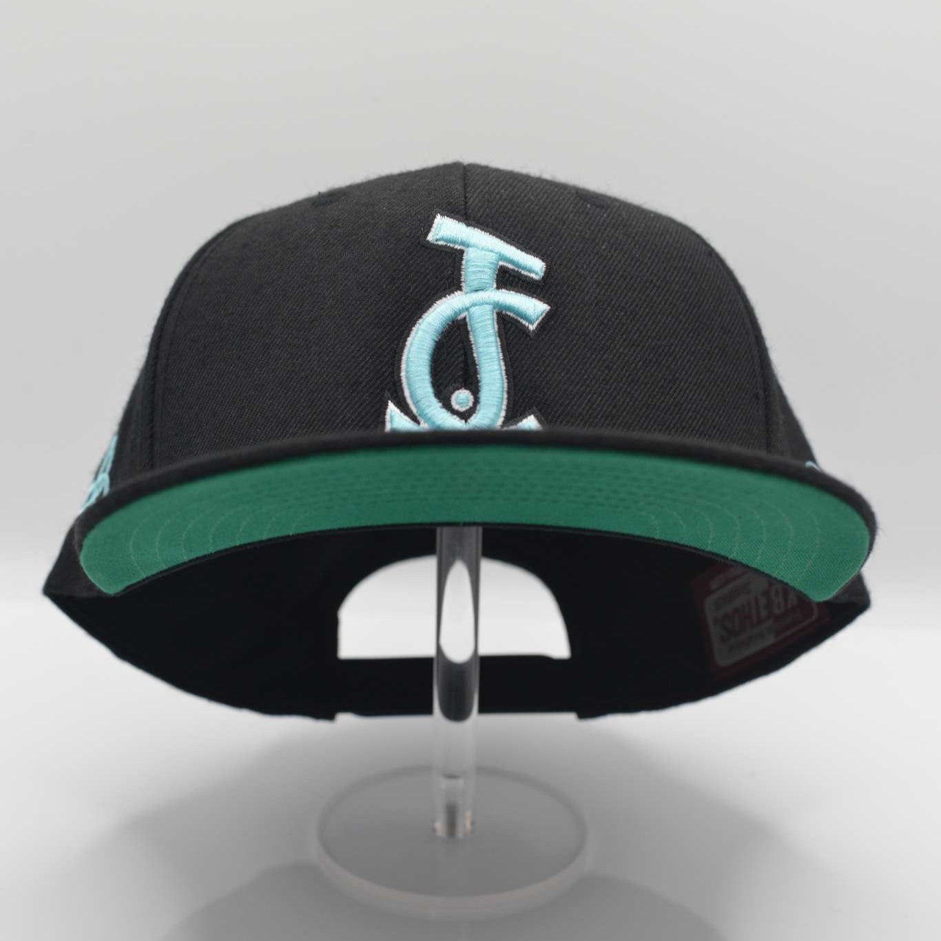 Boldly represent your faith with the Trinity Edition JC Snapback in black and teal. Side embroidery, sharp fit, and Christ-centered design from Aaron David Apparel.

